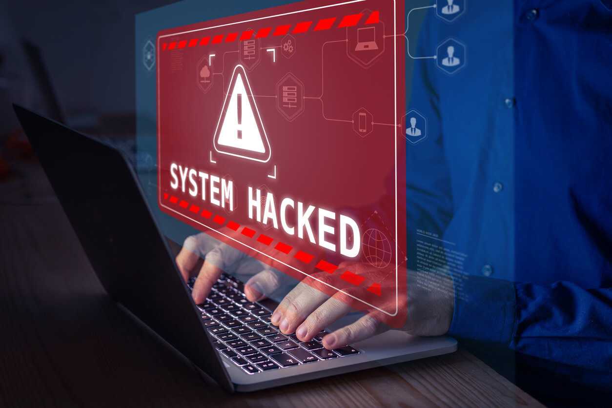 red sign above the laptop SYSTEM HACKED
